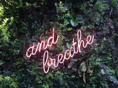and-breathe-neon-sign-on-a-green-wall-2022-11-11-10-39-23-utc